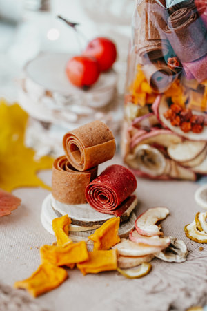Autumn still life with apples, dried fruit rolls and other dried fruits.の写真素材