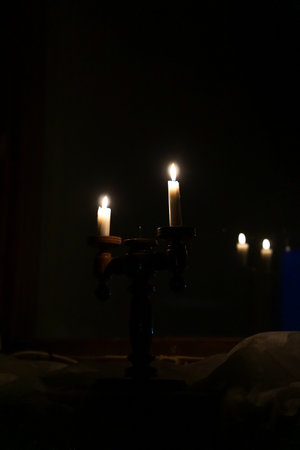 Candle light in the church at night. Selective focus.の写真素材