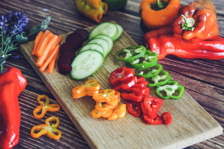 Slices of fresh vegetables on a cutting board. Healthy eating concept.の写真素材