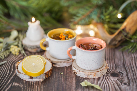 Cup of tea with lemon on a wooden background with Christmas decorationsの写真素材