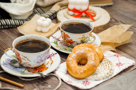 Two cups of coffee and donut on a wooden background. Still lifeの写真素材