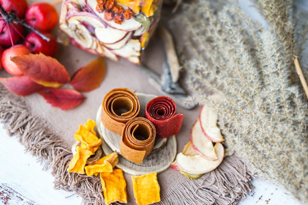 Autumn still life with dried fruits and candies on wooden backgroundの写真素材