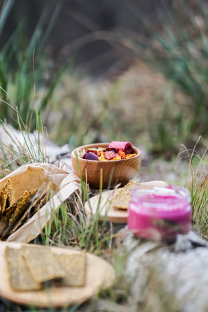 Healthy breakfast in the mountains. Muesli in a wooden bowl on a background of grass.の写真素材