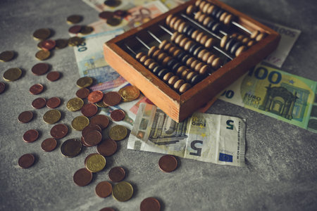Vintage abacus and euro banknotes on the grey background.の写真素材