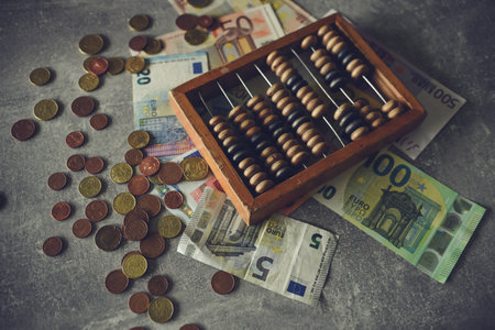 Abacus and euro banknotes on the table, retro tonedの写真素材