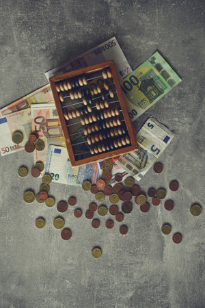 Abacus and euro banknotes on grey background, retro tonedの写真素材
