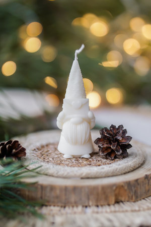 Christmas candle on a wooden background with bokehの写真素材