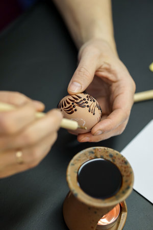 Close-up of a woman's hand painting a easter eggの写真素材