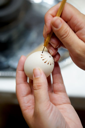 The process of painting Easter eggs in the kitchen. Selective focus.の写真素材