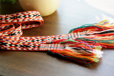 Close up of colorful textile band - national Lithuanian accessory, on wooden table. Selective focus.の写真素材