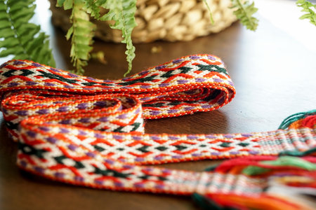 Close up of colorful textile band - national Lithuanian accessory, on wooden table. Selective focus.の写真素材