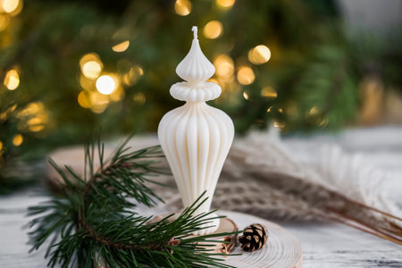 Christmas still life with candles, fir branches and cones on a wooden backgroundの写真素材