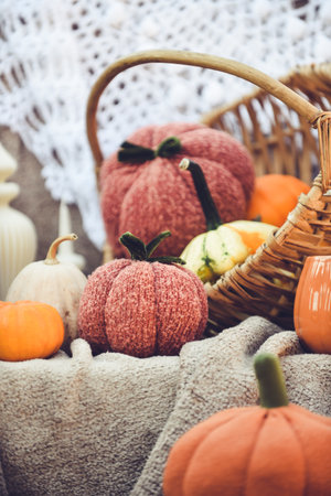 Autumn composition with pumpkins, candles and knitted blanket.の写真素材