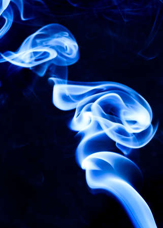 Bright blue, luminescent smoke with a white tinge forms a vortex like a hurricane. Fantasy and magic photography.の写真素材