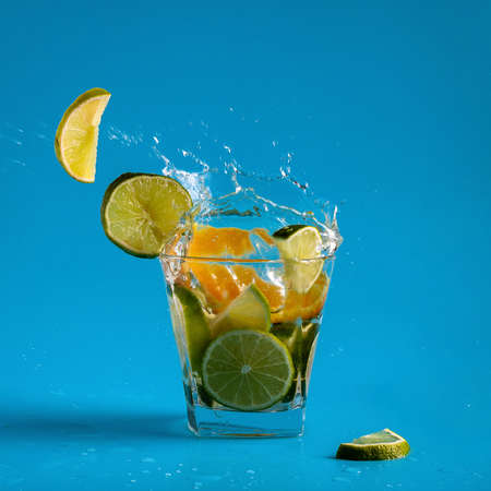 Flying slices of lime and orange in a refreshing summer lemonade