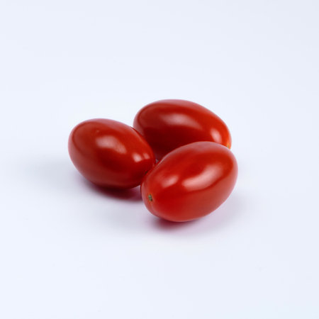 Three oval plums, small tomatoesの写真素材