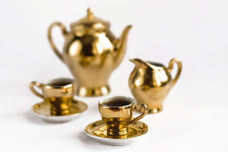 Golden coffee cups and potsの写真素材