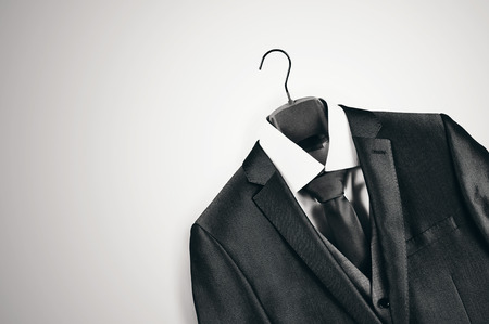 Black and white mens suit on clothes hanger.の写真素材