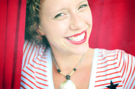 Portrait of a cheerful smiling happy young woman with dark hair and red lipsの写真素材