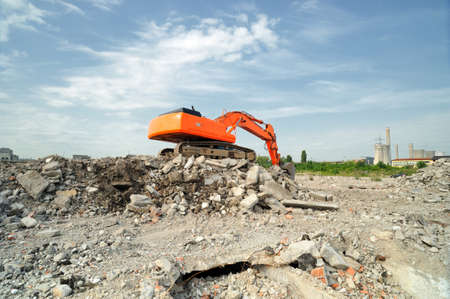 Demolition construction site in daytime. Crawler excavator working on demolition site in daytime.の写真素材