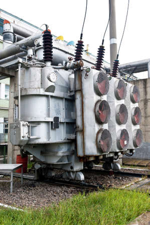 Power transformer. Lateral view of the big electric power transformer from the electrical power...