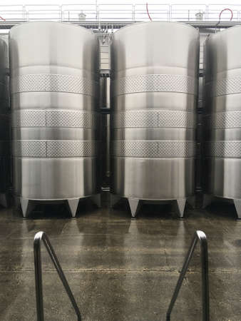 Wine fermentation tanks. New modern wine fermentation tanks in the factory courtyard.