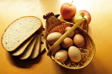 Easter is coming. Fresh chicken eggs in wicker basket on the table in the kitchen.の写真素材