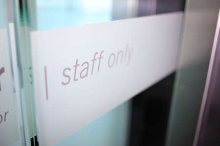 Staff only restricted area. Staff only sign on a private room door inside office building only for staff members.の写真素材