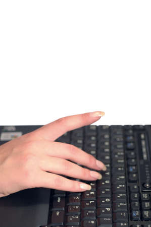 Female user pointing at the screen while typingの写真素材