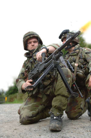Soldiers firing machine gun