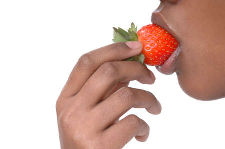 Girl eating strawberry isolated on whiteの写真素材