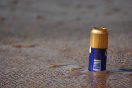 Beer can in the sandの写真素材
