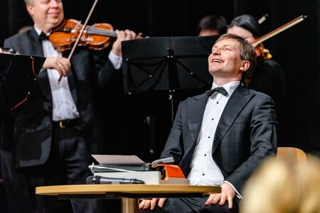 VILNIUS, LITHUANIA - FEBRUARY 24, 2019: The four-day 20th International Vilnius Book Fair. The Vilnius City Municipality Christopher Chamber Orchestra is playing. In front - chief conductor M.Barkauskasのeditorial素材