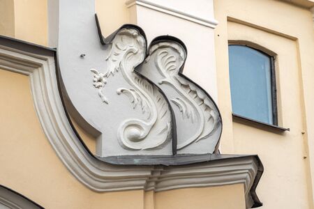 Vilnius, Lithuania - October 26, 2019: Typical Baroque architectural detail in Eastern Europe. Exterior fragment of one of the churches of Vilnius. Decoration above the door, moldingのeditorial素材
