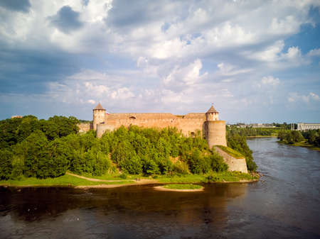 The amazing summer view of the old fortress in Ivangorod, Russia, on the Bank of the Narva river from Narva castle in Estonia. Copy spaceのeditorial素材