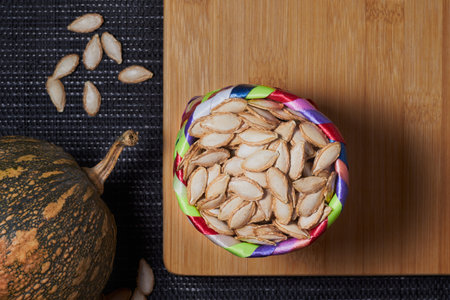 A vibrant pile of fresh, seeds and pumpkins harvested in season for a healthy vegetarian diet. The colors and textures provide nutrition and well being.の写真素材