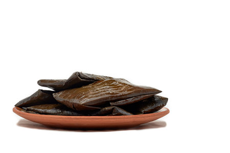 Authentic Mexican tamales, hot and steamed, on white background.の写真素材