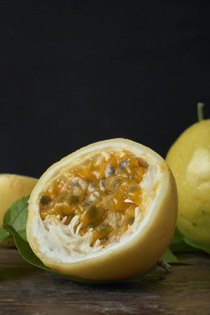 Ripe passion fruit with seeds and pulp displayed in a cross-section view.