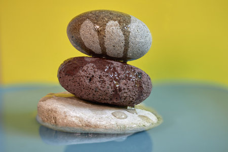 Stacked Stones On Water: Calm Zen Balance Moment For Mindful Wellnessの写真素材