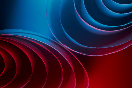 Vibrant abstract composition featuring layered circular spirals in blue and red gradients. A dynamic, modern background perfect for creative projects, technology visuals, and design presentations seeking bold color and motion.の写真素材