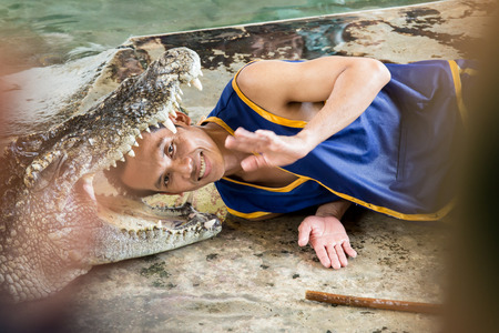 Samphran Elephant Groune and Zoo Nakorn Prathom THAILAND - 31 August 2013 - Wrestlers performing a crocodile show のeditorial素材