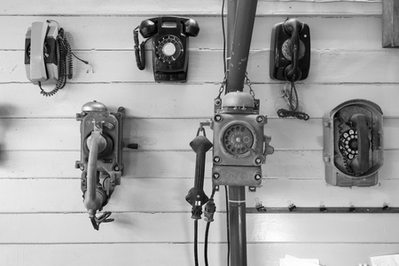 Old telephone collection on the wall.の写真素材