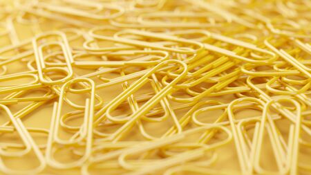 Bunch of paper clips of single color on yellow background