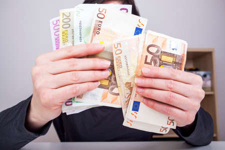 Hand holding paper moneyの写真素材