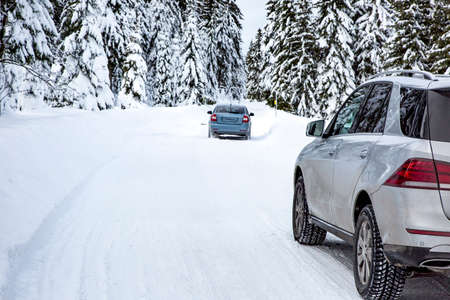 Car in snow-covered winter sceneryの写真素材