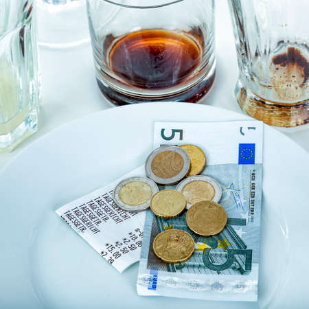 Empty glasses and plates with tipの写真素材