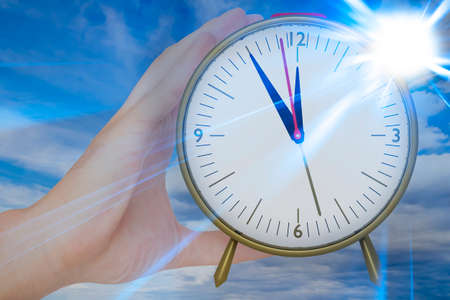 Hand holding electric radio alarm clock