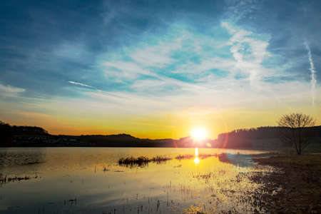 Moody sunrise at the lakeの写真素材