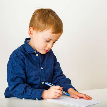 Child with paper and penの写真素材