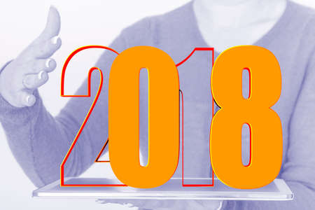 Person with tablet PC and year 2018の写真素材
